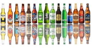 Blog 18 A variety of beer bottles showcasing different styles and labels arranged on a wooden surface.
